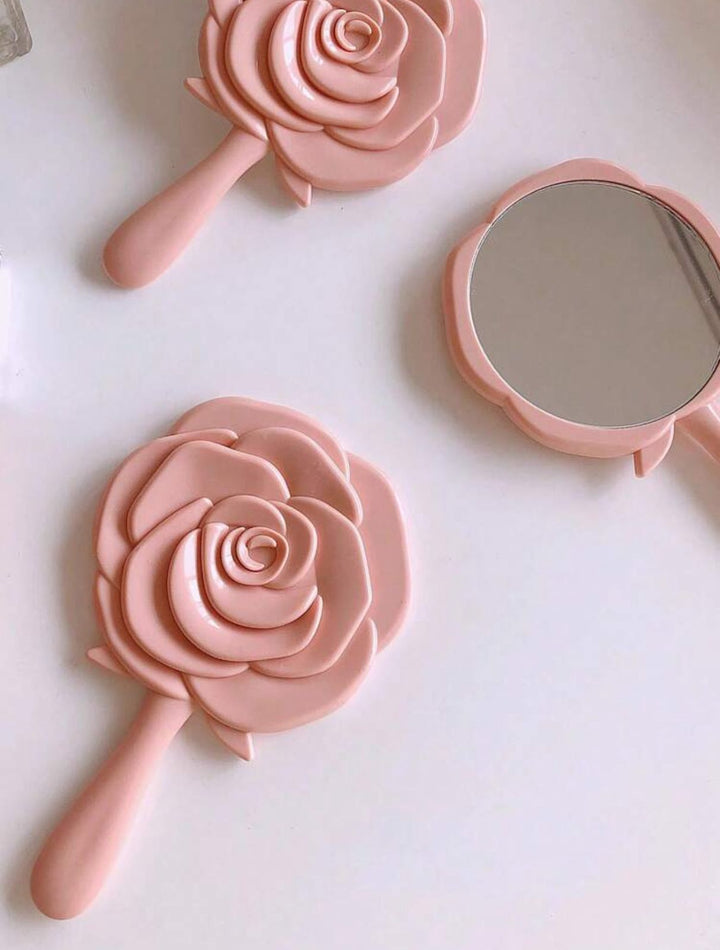 Carnation-colored mirror in the shape of a rose | مرآة يد بتصميم وردة
