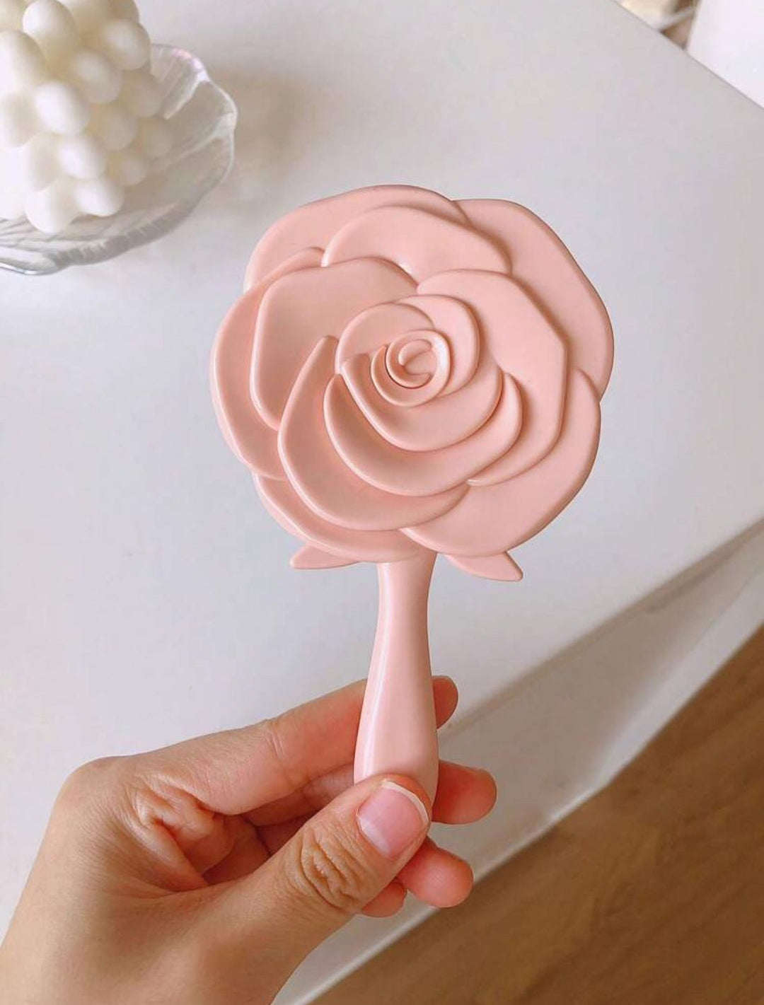 Carnation-colored mirror in the shape of a rose | مرآة يد بتصميم وردة